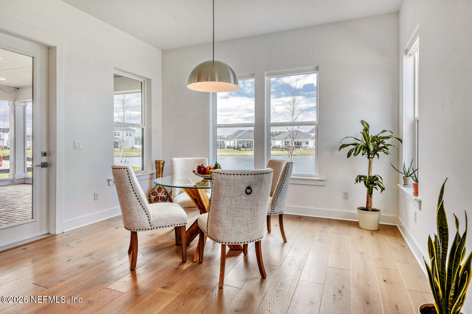 279 Bismarck Palm Road St. Augustine, FL 32092 - Photo 7 of 38 a view of a dining room with furniture window and wooden floor