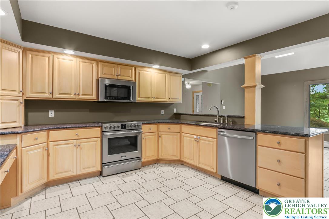 376 H T Y Road Kunkletown, PA 18058 - Photo 41 of 80 a kitchen with granite countertop white cabinets stainless steel appliances and a sink