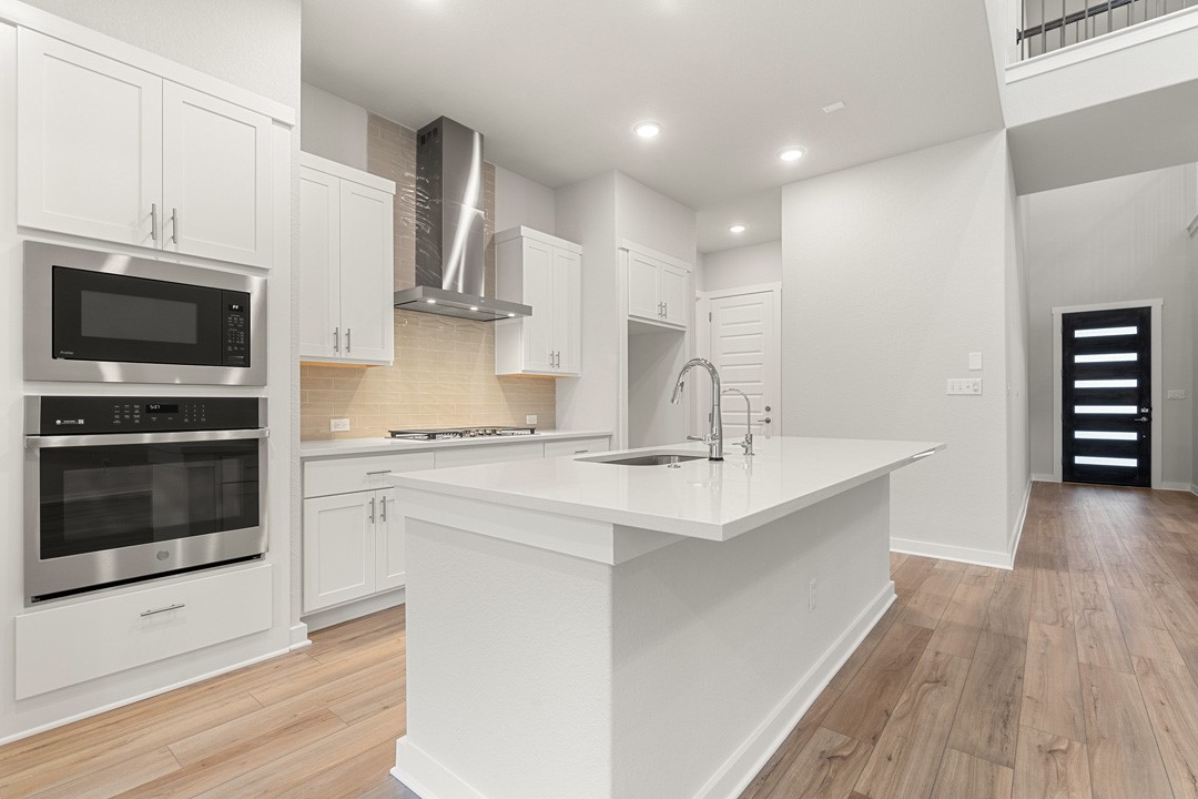 101 Old Wds Road Liberty Hill, TX 78642 - Photo 11 of 40 a kitchen with stainless steel appliances a sink stove and microwave