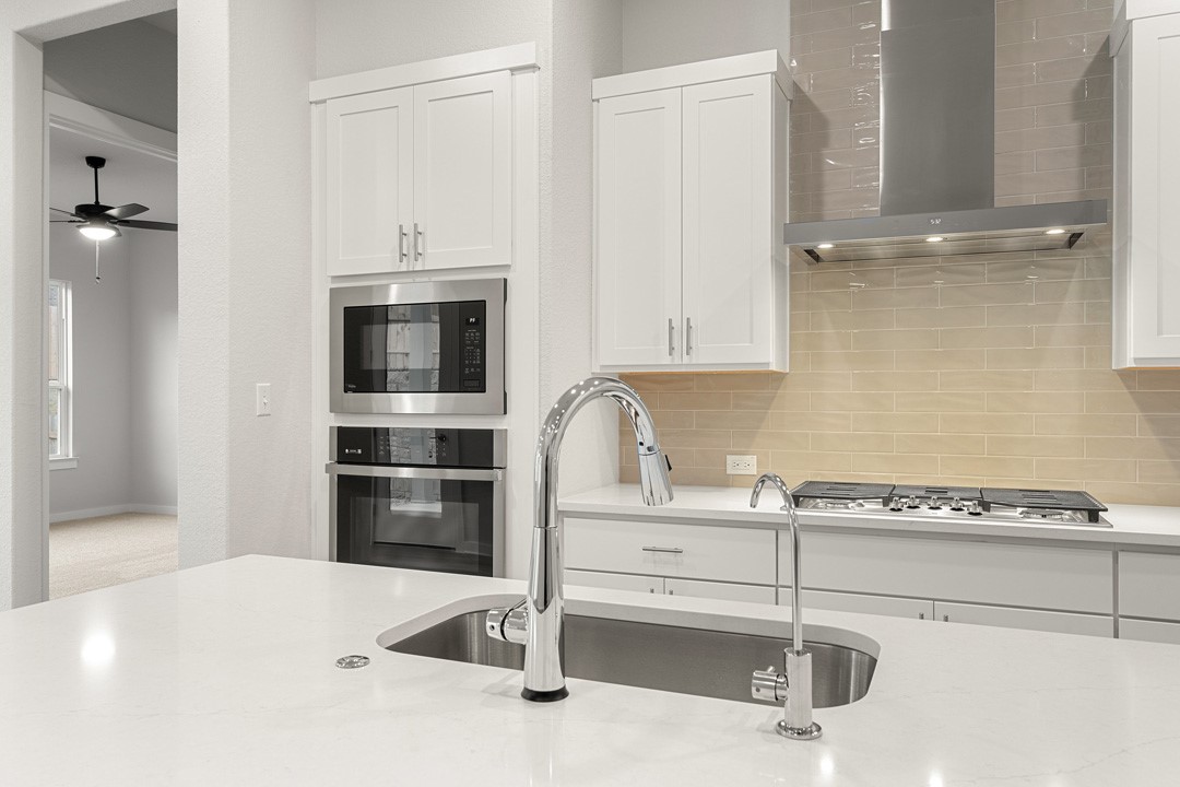 101 Old Wds Road Liberty Hill, TX 78642 - Photo 13 of 40 a kitchen with a refrigerator and a sink