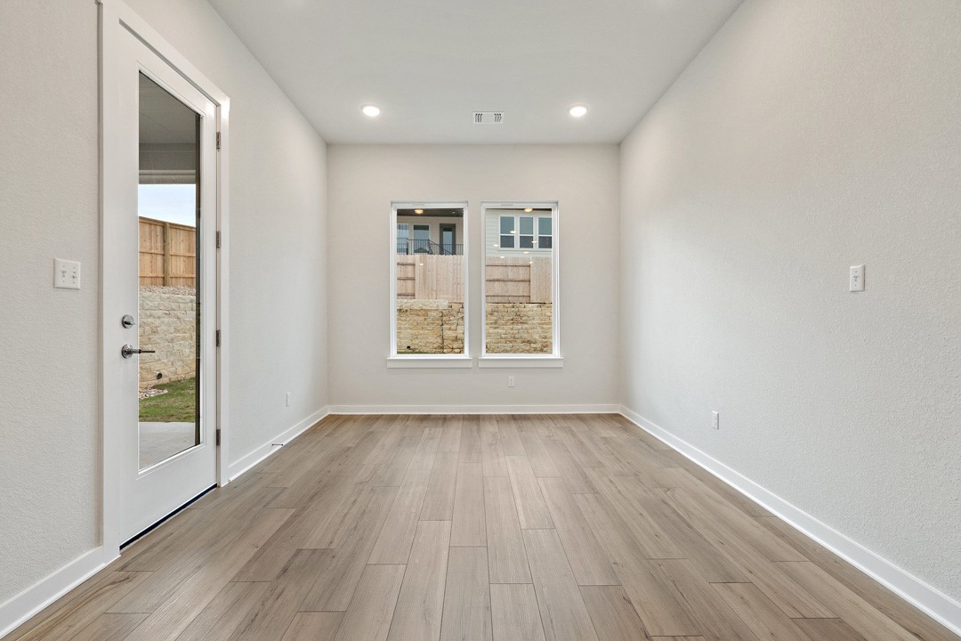 101 Old Wds Road Liberty Hill, TX 78642 - Photo 15 of 40 an empty room with wooden floor and windows