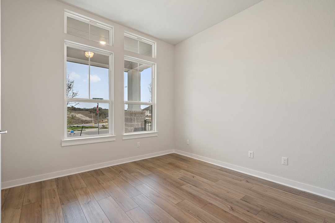 101 Old Wds Road Liberty Hill, TX 78642 - Photo 17 of 40 an empty room with wooden floor and windows