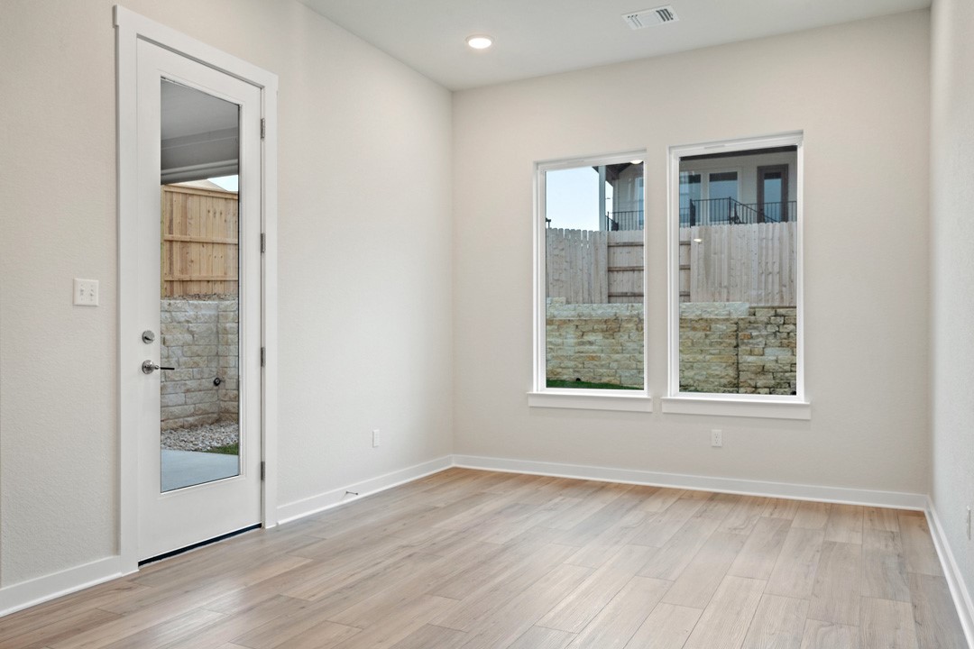 101 Old Wds Road Liberty Hill, TX 78642 - Photo 20 of 40 an empty room with wooden floor and windows