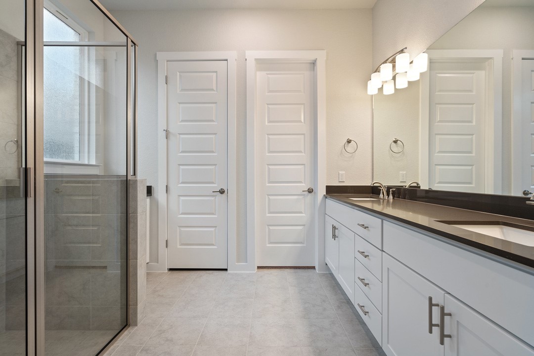 101 Old Wds Road Liberty Hill, TX 78642 - Photo 25 of 40 a spacious bathroom with a granite countertop sink a mirror and a shower