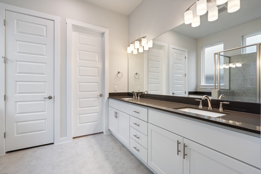 101 Old Wds Road Liberty Hill, TX 78642 - Photo 26 of 40 a bathroom with a double vanity sink and a mirror