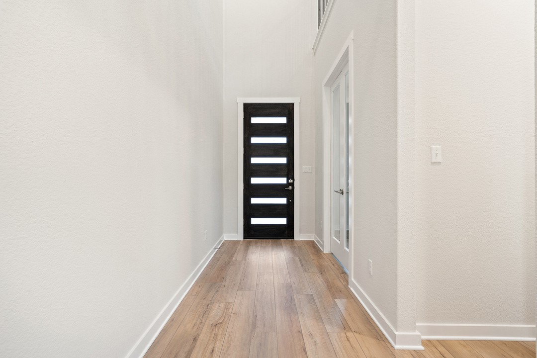 101 Old Wds Road Liberty Hill, TX 78642 - Photo 3 of 40 a view of a hallway with wooden floor and closet