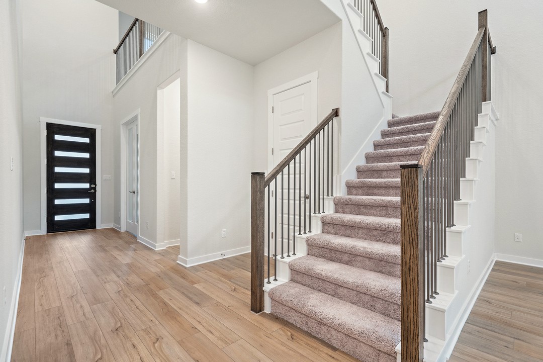 101 Old Wds Road Liberty Hill, TX 78642 - Photo 4 of 40 a view of a hallway with wooden floor and entryway