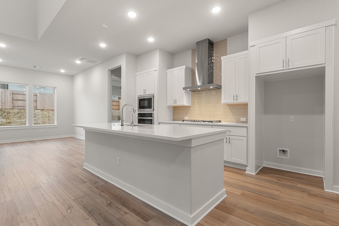 101 Old Wds Road Liberty Hill, TX 78642 - Photo 9 of 40 a kitchen with stainless steel appliances granite countertop a refrigerator and a stove top oven