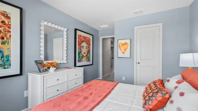 a bedroom with a bed and cupboard