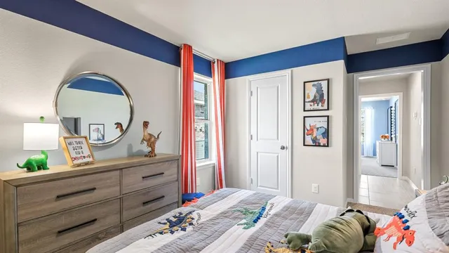 a bedroom with a bed and painting on the wall