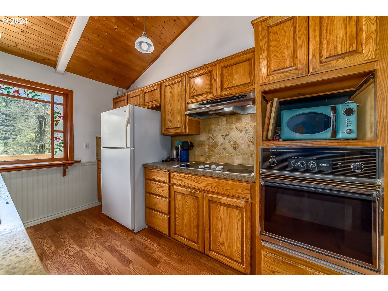 28149 Briggs Hill Road Eugene, OR 97405 - Photo 11 of 37 a kitchen with stainless steel appliances granite countertop a refrigerator and a stove top oven