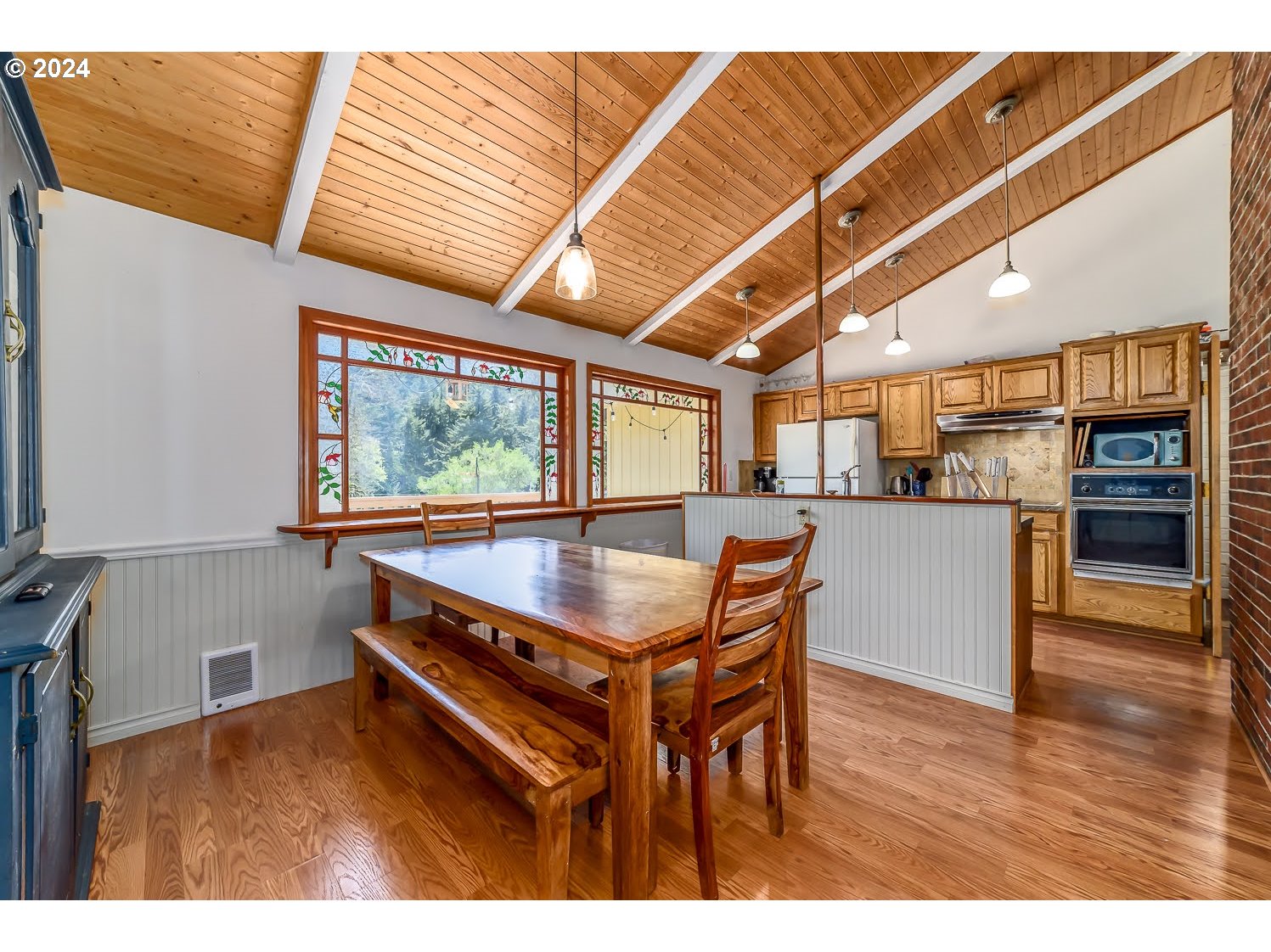 28149 Briggs Hill Road Eugene, OR 97405 - Photo 15 of 37 a room with stainless steel appliances kitchen island granite countertop a table chairs and a wooden floors