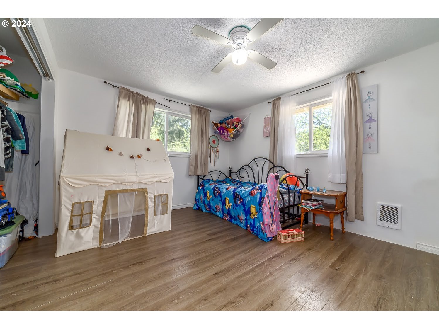 28149 Briggs Hill Road Eugene, OR 97405 - Photo 24 of 37 a bedroom with furniture and a wooden floor