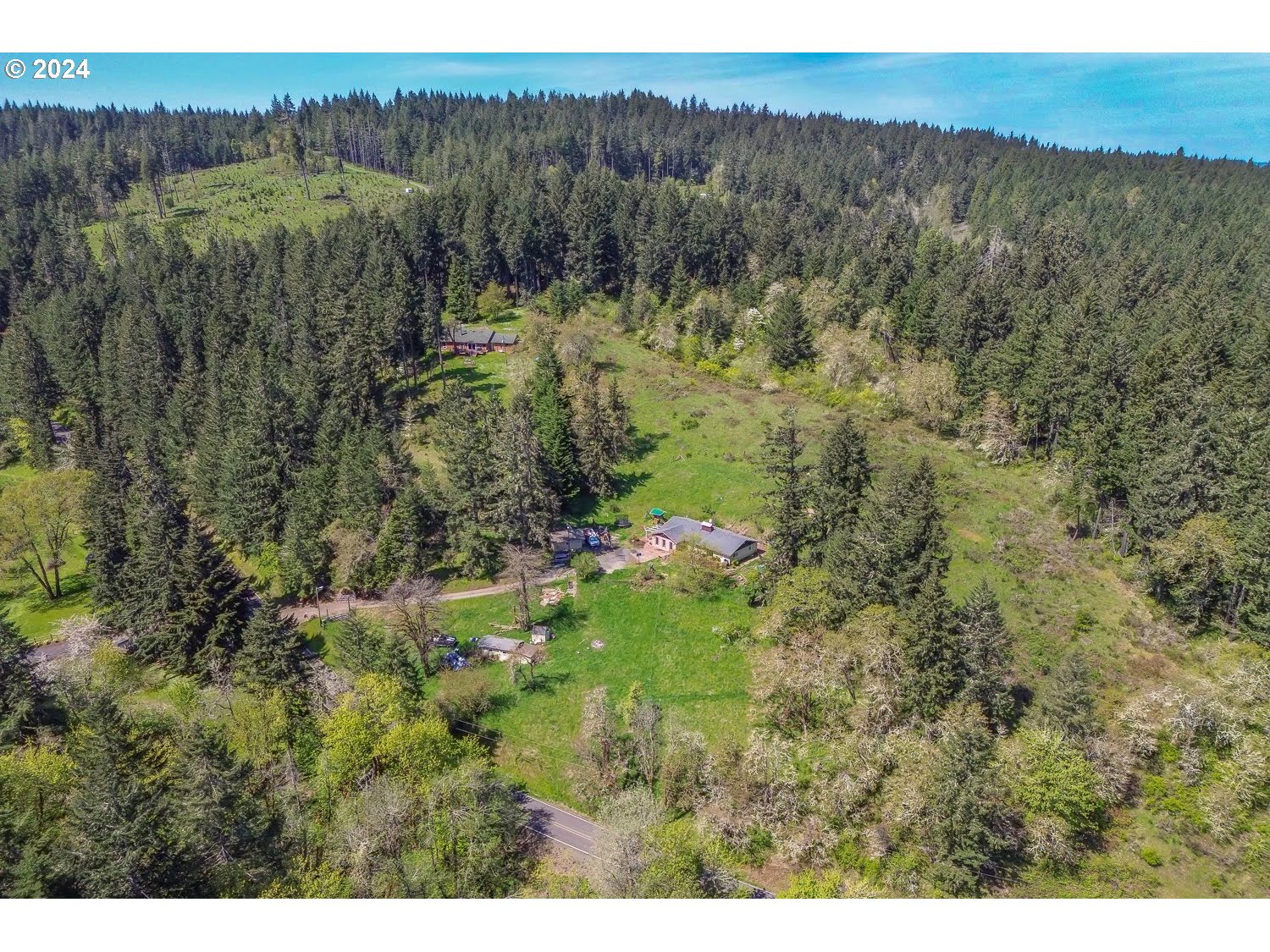 28149 Briggs Hill Road Eugene, OR 97405 - Photo 36 of 37 a view of a lush green hillside and a building