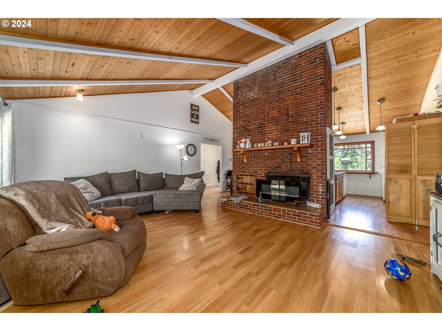 28149 Briggs Hill Road Eugene, OR 97405 - Photo 8 of 37 a living room with furniture a fireplace and a flat screen tv