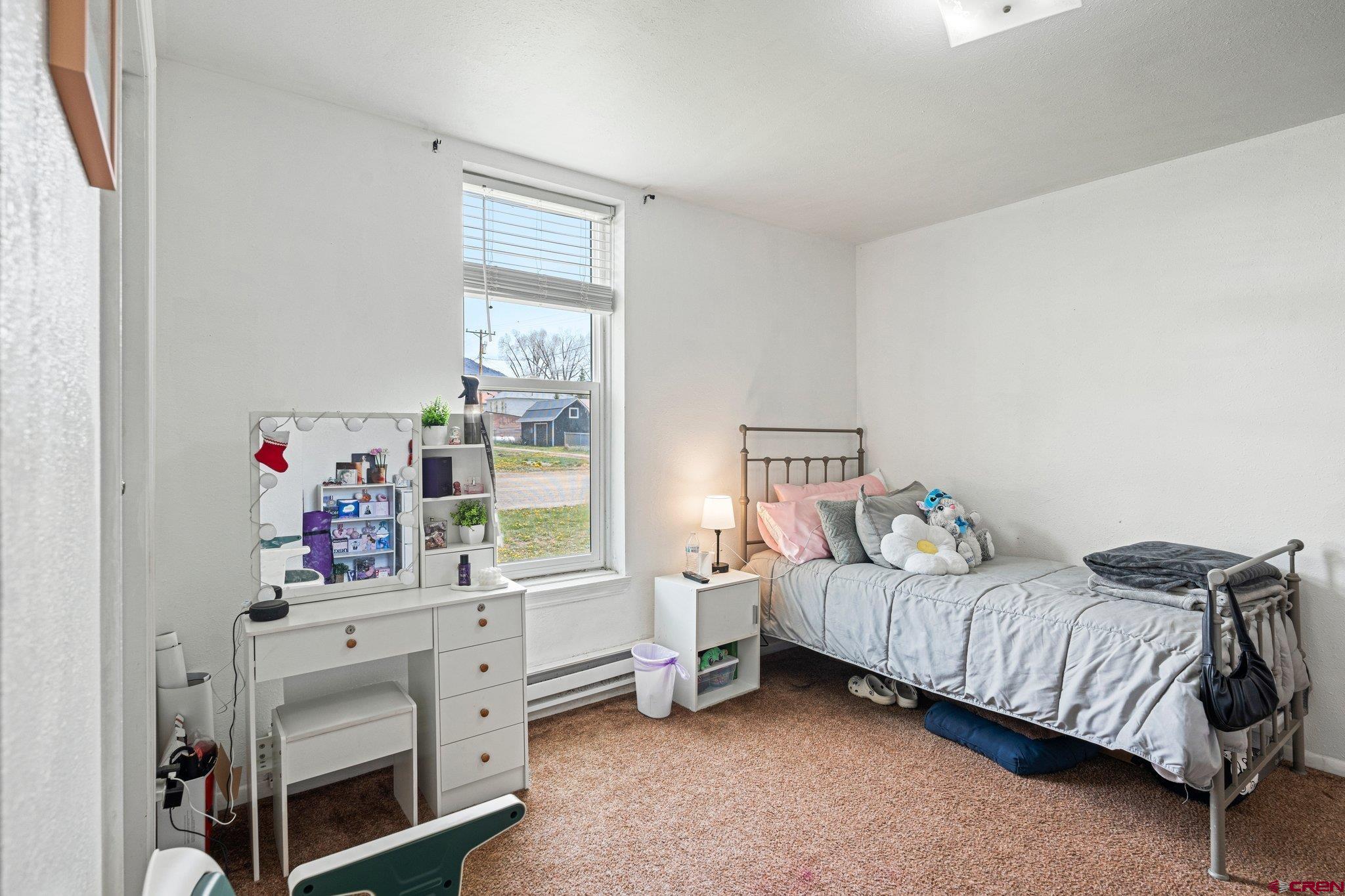 754 Greene Street, Unit A B C D Silverton, CO 81433 - Photo 12 of 31 a bedroom with a bed and a window