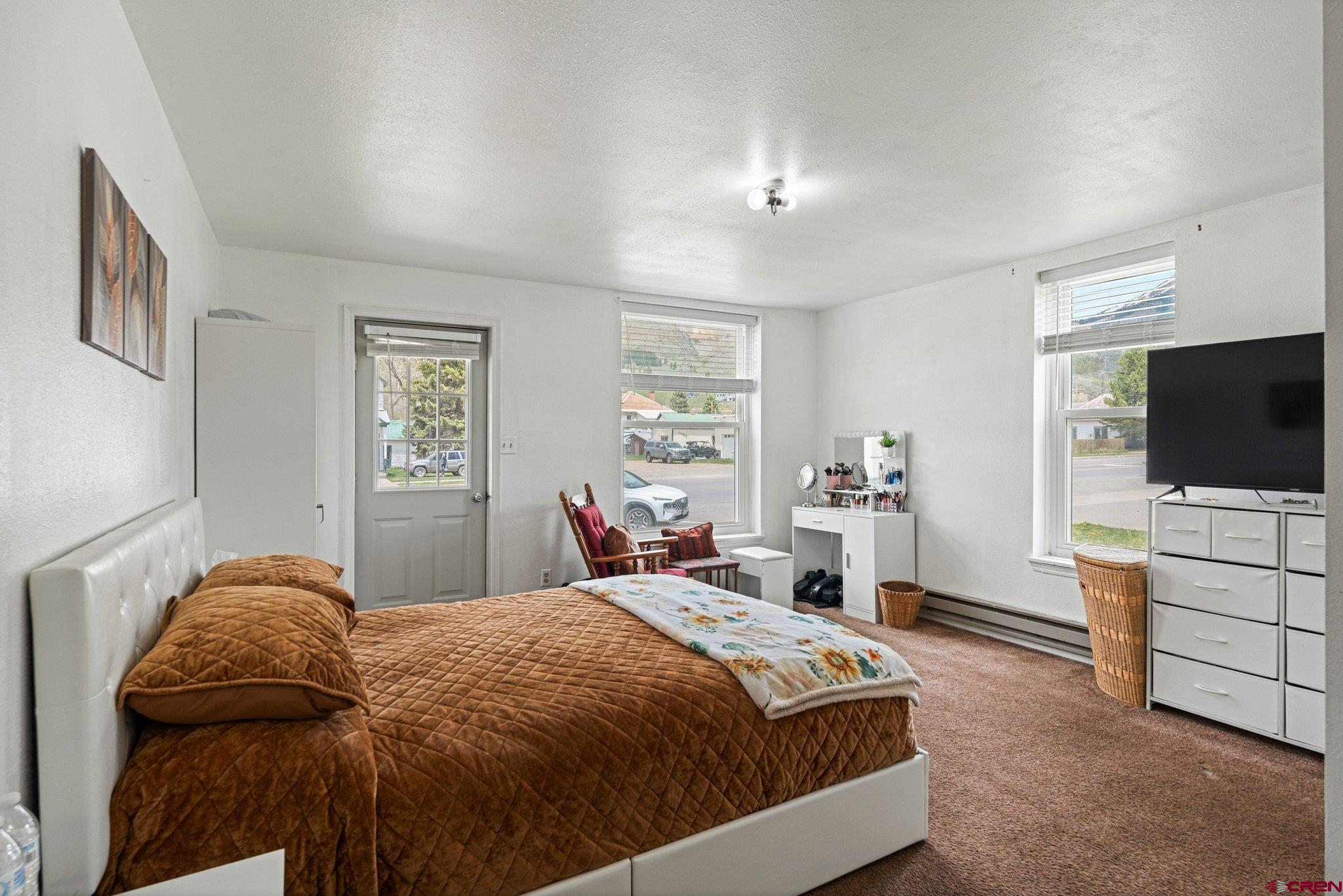 754 Greene Street, Unit A B C D Silverton, CO 81433 - Photo 13 of 31 a bedroom with a bed and a flat screen tv