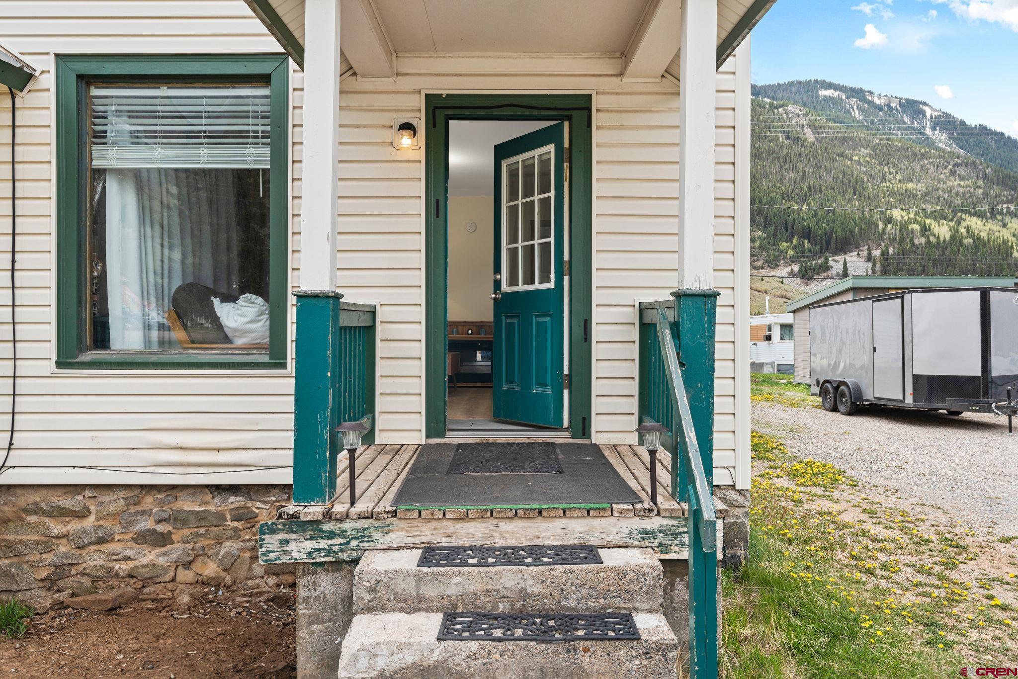 754 Greene Street, Unit A B C D Silverton, CO 81433 - Photo 2 of 31 a view of a house with a floor to ceiling window and wooden fence