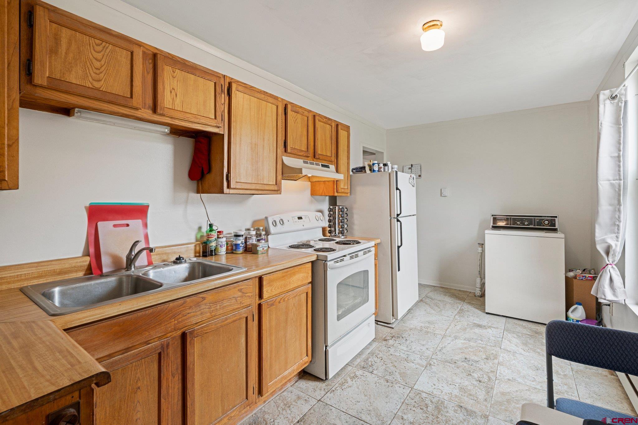 754 Greene Street, Unit A B C D Silverton, CO 81433 - Photo 24 of 31 a kitchen with stainless steel appliances granite countertop a sink stove refrigerator and cabinets