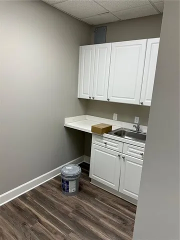 a kitchen with a sink cabinets and a stove