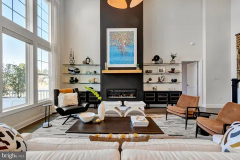 a view of a hallway with wooden floor and a bathroom