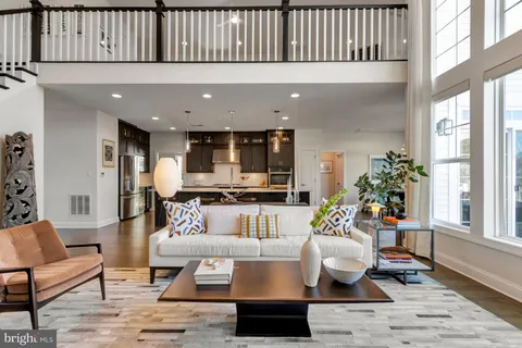 a living room with furniture a table and chairs