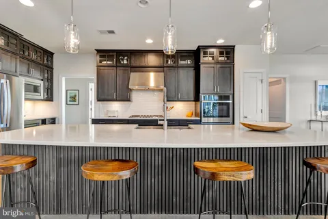 a living room with furniture a table and a chandelier