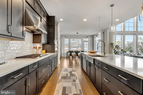 a living room with furniture a rug and wall paintings