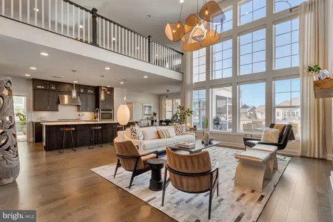 a living room with furniture a fireplace and a large window