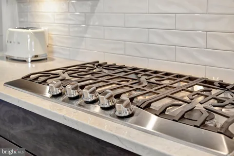 a living room with furniture a rug and white walls