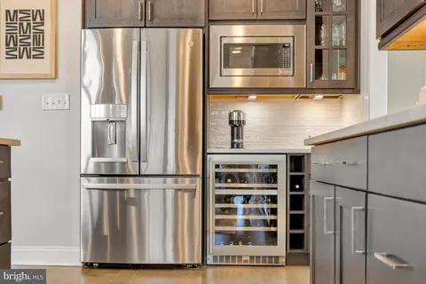 a living room with furniture a large window and a flat screen tv
