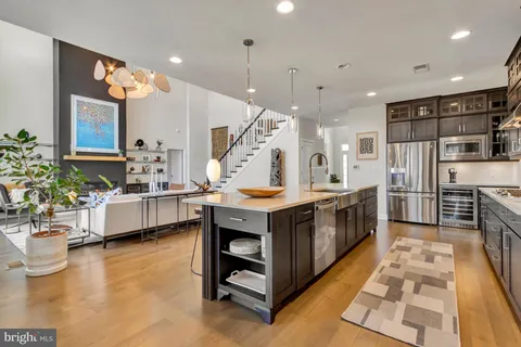 a bathroom with a sink a toilet and a large mirror