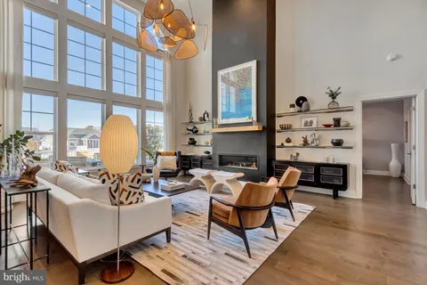 a living room with furniture a large window and a flat screen tv