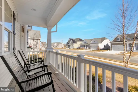 a living room with furniture a fireplace and a large window
