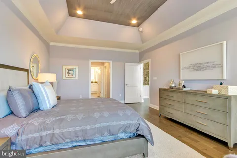 a living room with furniture a wooden floor and a large window