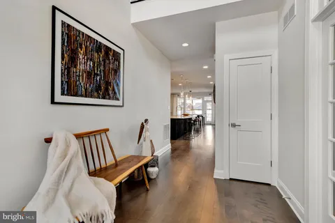 a living room with furniture and painting on the wall