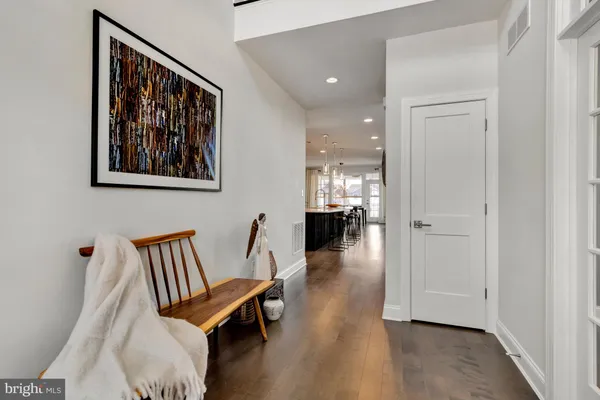 a living room with furniture and painting on the wall
