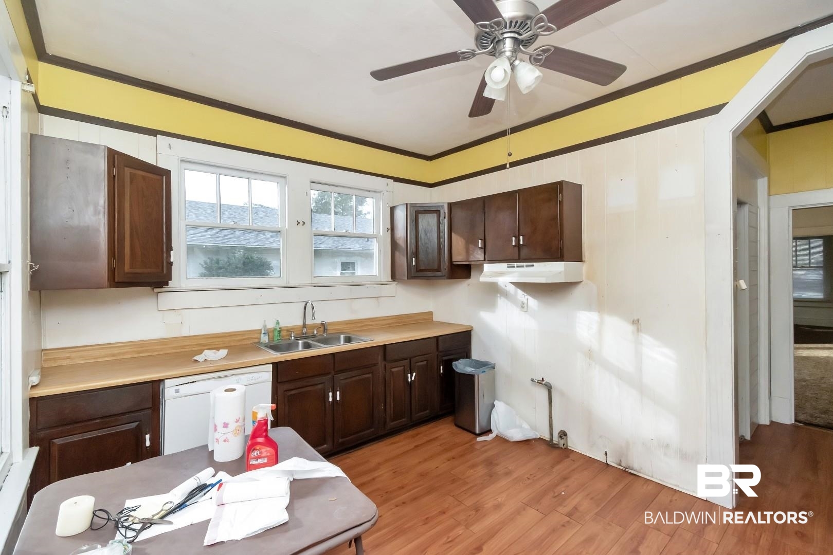 4305 Stein Street Mobile, AL 36608 - Photo 11 of 22 Kitchen featuring ornamental molding, dark brown cabinetry, sink, dishwasher, and light hardwood / wood-style floors