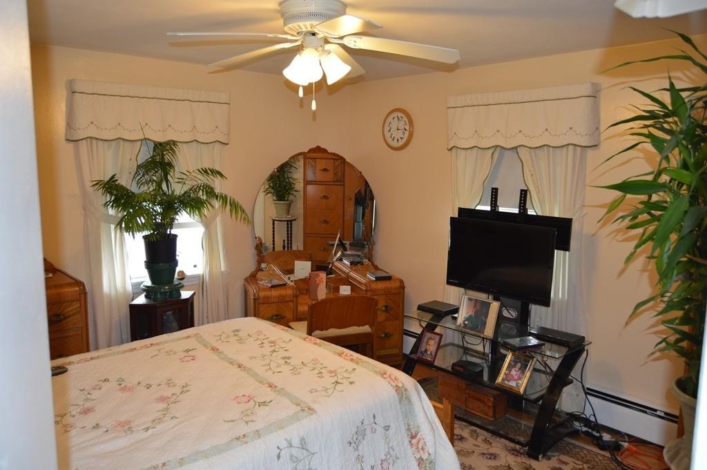 23 Fredette Street Springfield, MA 01109 - Photo 8 of 14 a bedroom with a bed and a chandelier