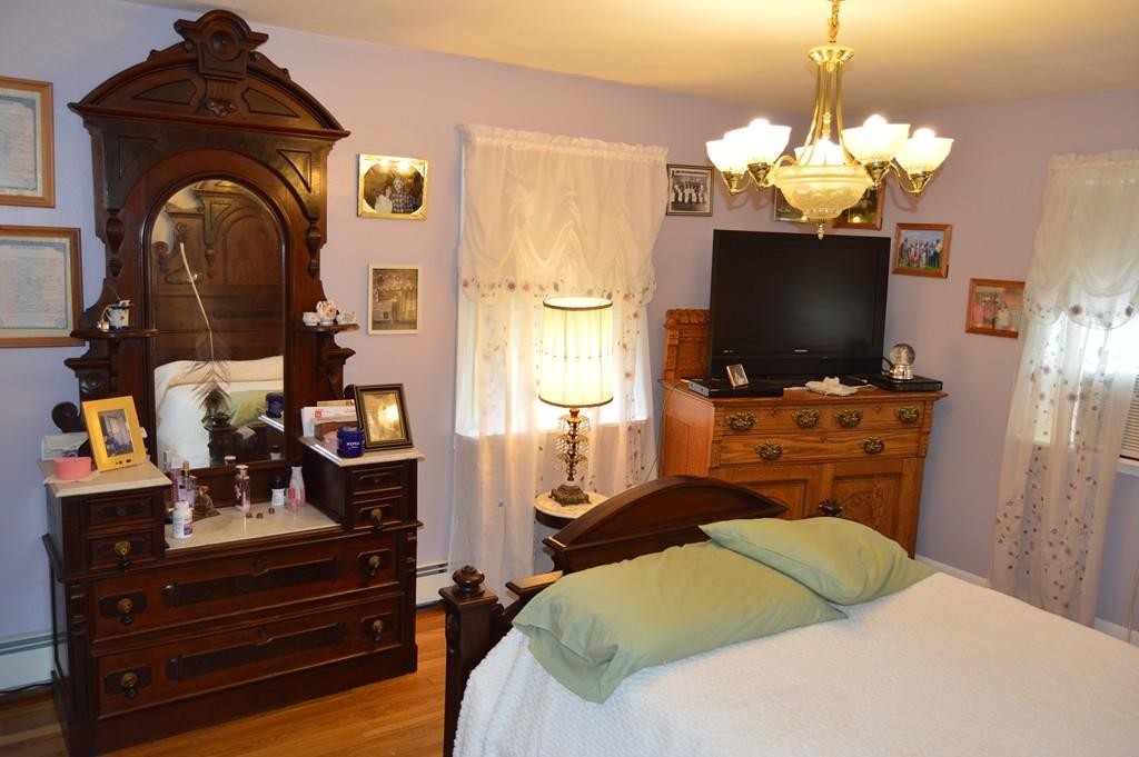 23 Fredette Street Springfield, MA 01109 - Photo 9 of 14 a bedroom with a bed and flat screen tv