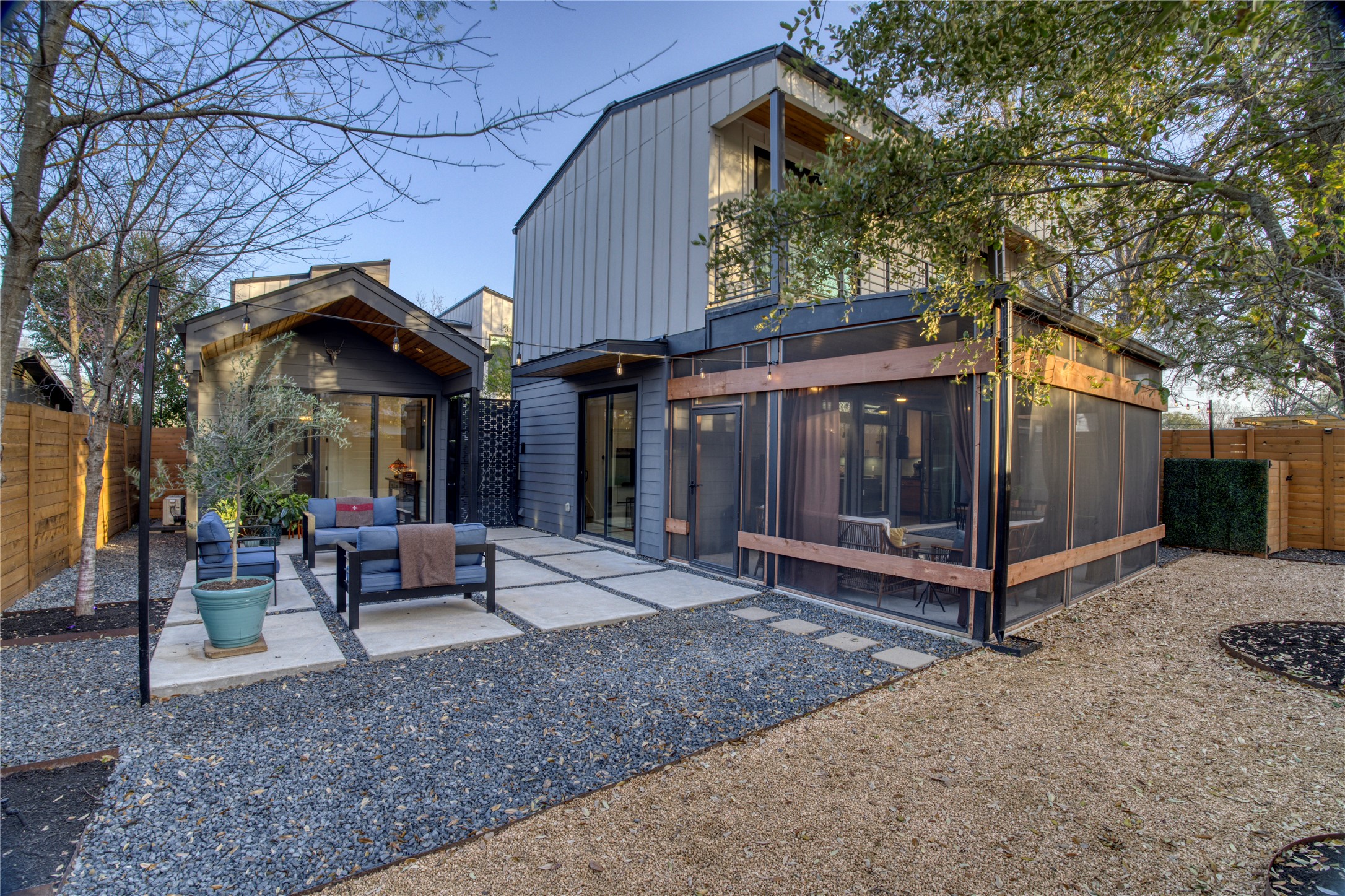 Back of property with an outdoor hangout area, a screened-in porch/patio, a outdoor patio, and a fenced backyard