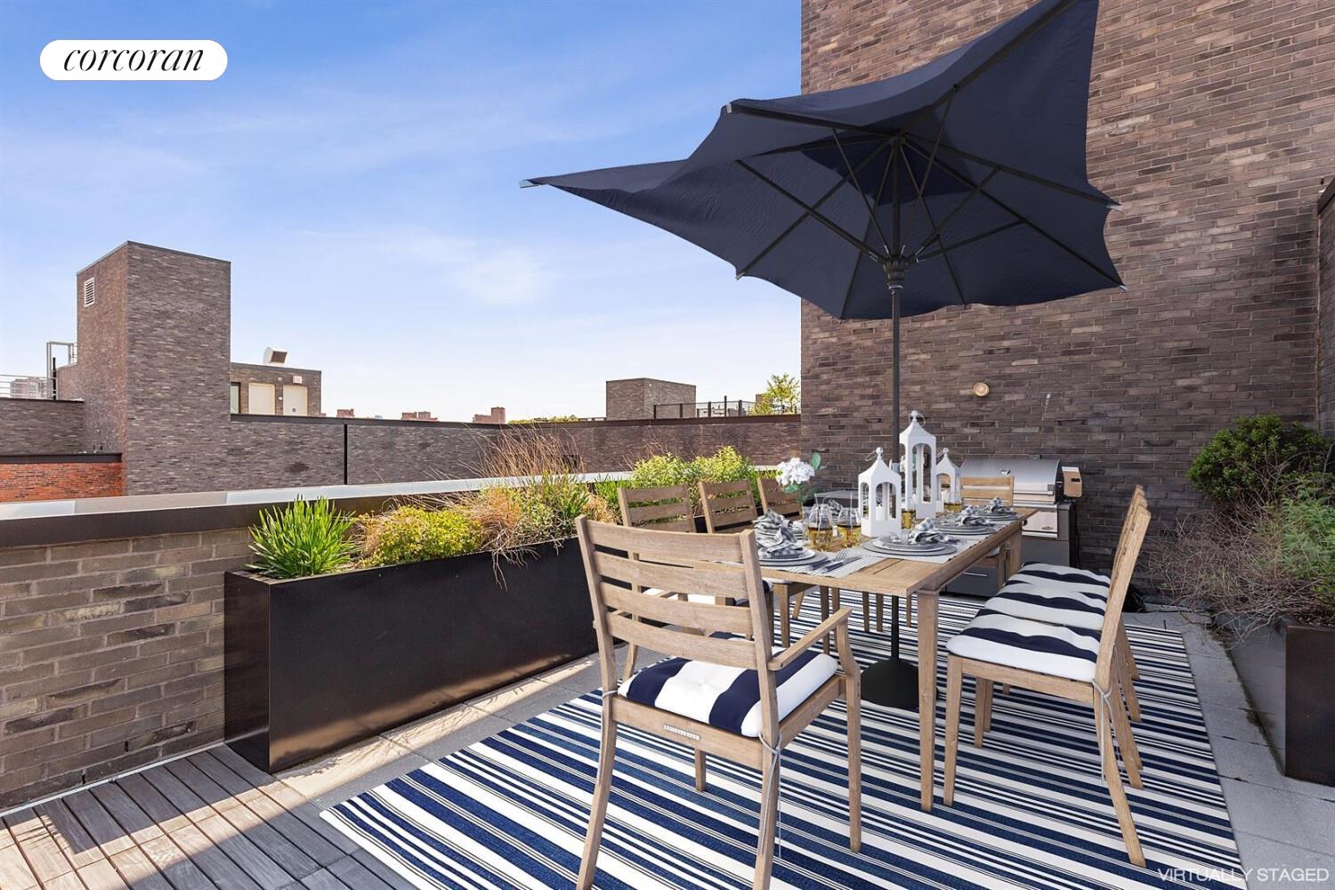 438 East 12th Street, Unit PHH Manhattan, NY 10009 - Photo 2 of 13 a view of a roof deck with table and chairs under an umbrella with a barbeque