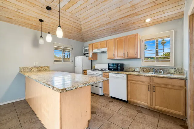 a kitchen with a stove sink and cabinets