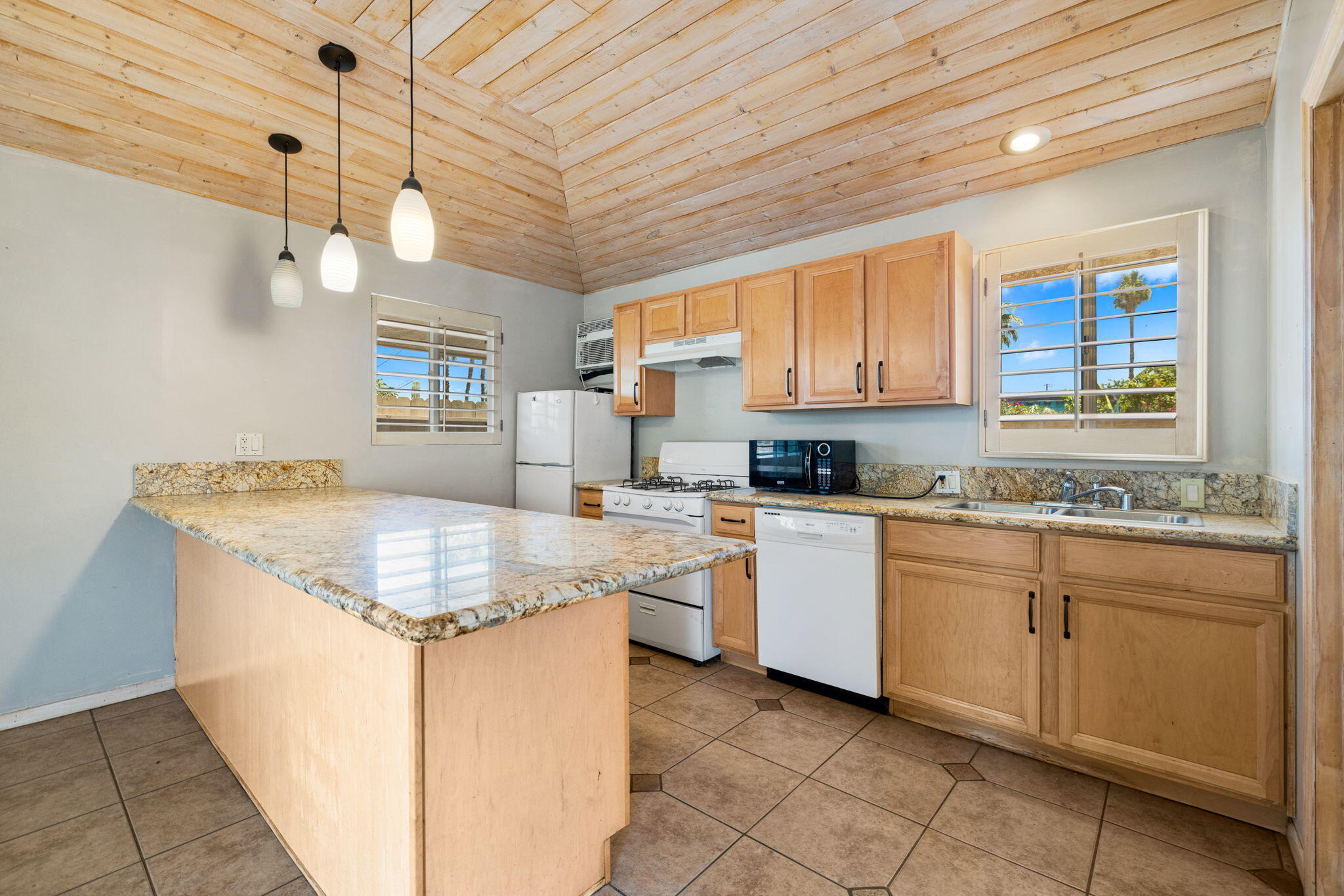 44510 San Carlos Avenue, Unit 4 Palm Desert, CA 92260 - Photo 6 of 12 a kitchen with a stove sink and cabinets