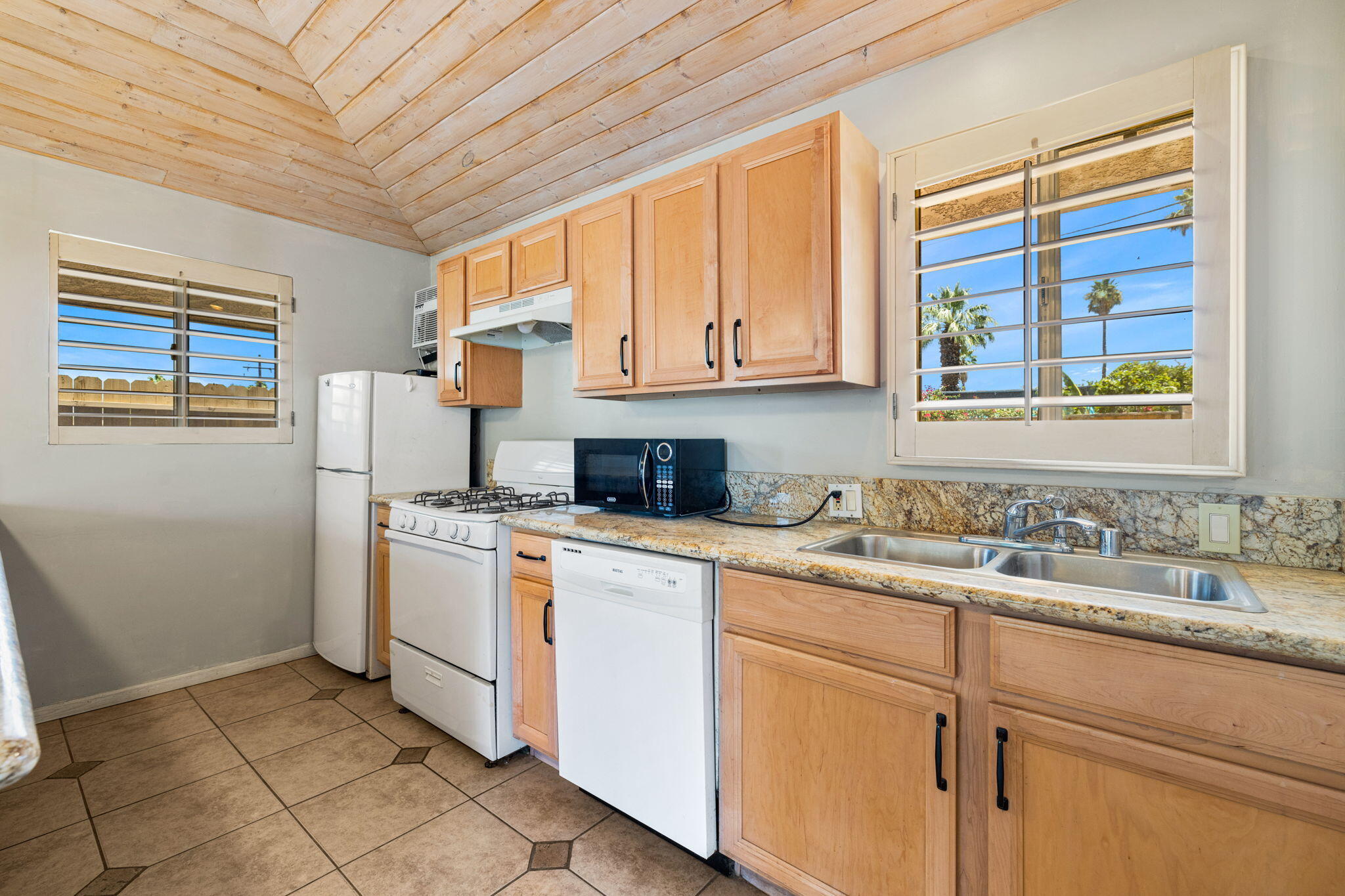 44510 San Carlos Avenue, Unit 4 Palm Desert, CA 92260 - Photo 8 of 12 a kitchen with stainless steel appliances granite countertop a sink stove and cabinets