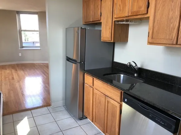 a kitchen with a refrigerator and a sink