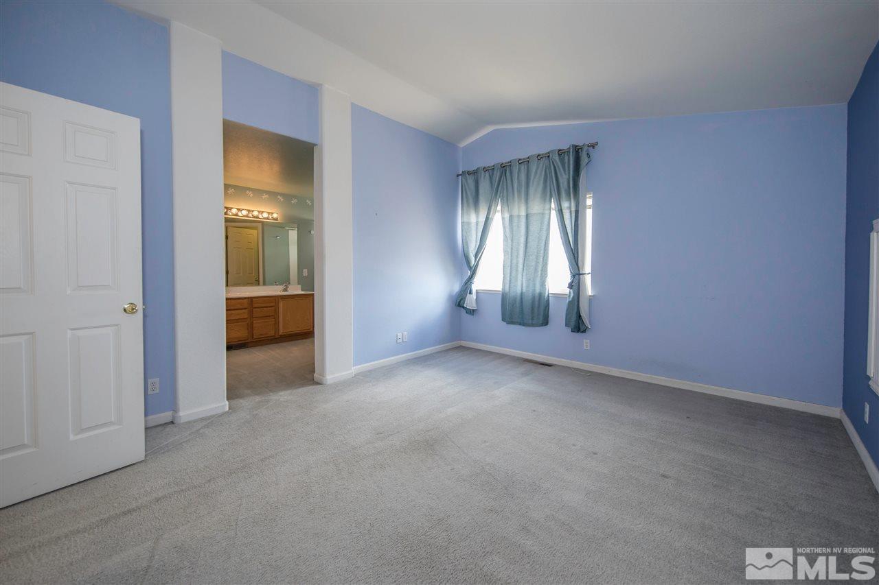 9910 Rock River Drive Reno, NV 89506 - Photo 12 of 24 an empty room with closet and windows