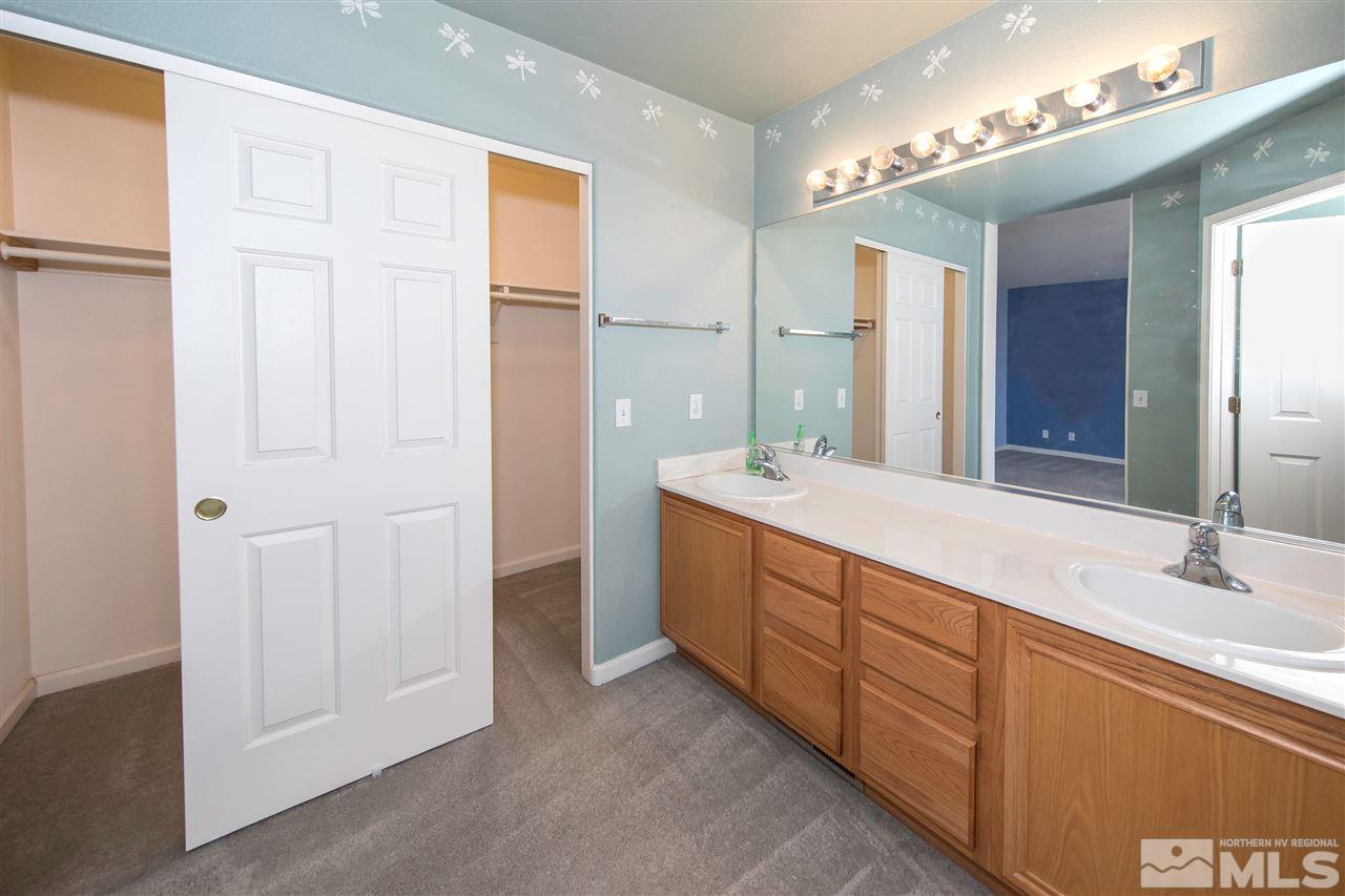 9910 Rock River Drive Reno, NV 89506 - Photo 13 of 24 a bathroom with double vanity sink and a mirror