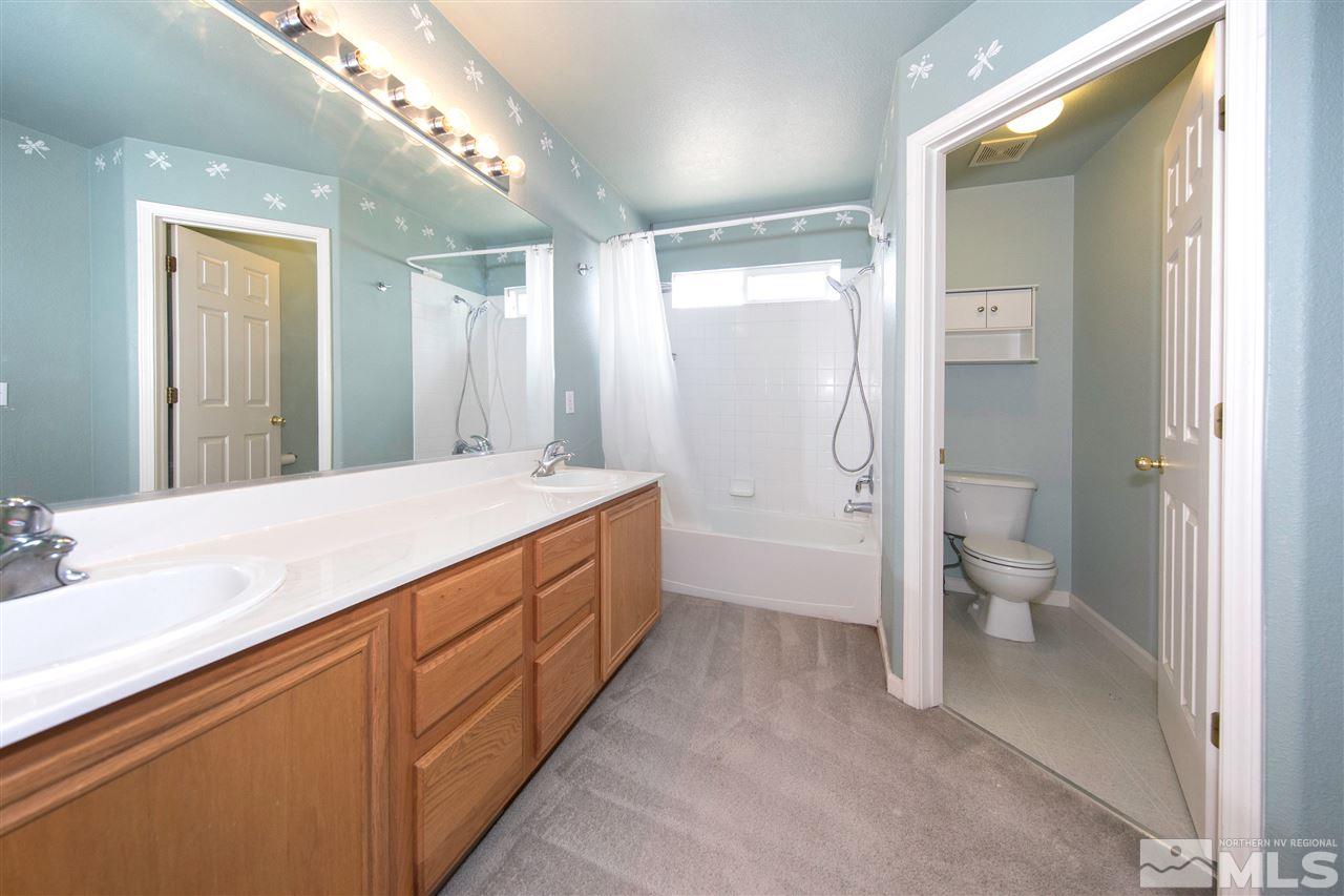 9910 Rock River Drive Reno, NV 89506 - Photo 14 of 24 a spacious bathroom with a double vanity sink toilet and shower