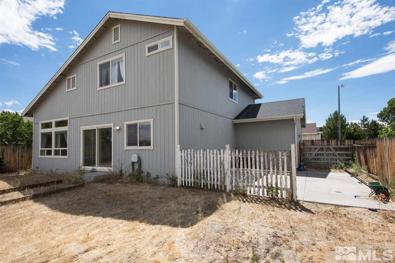 9910 Rock River Drive Reno, NV 89506 - Photo 22 of 24 a view of a house with a small yard and wooden fence